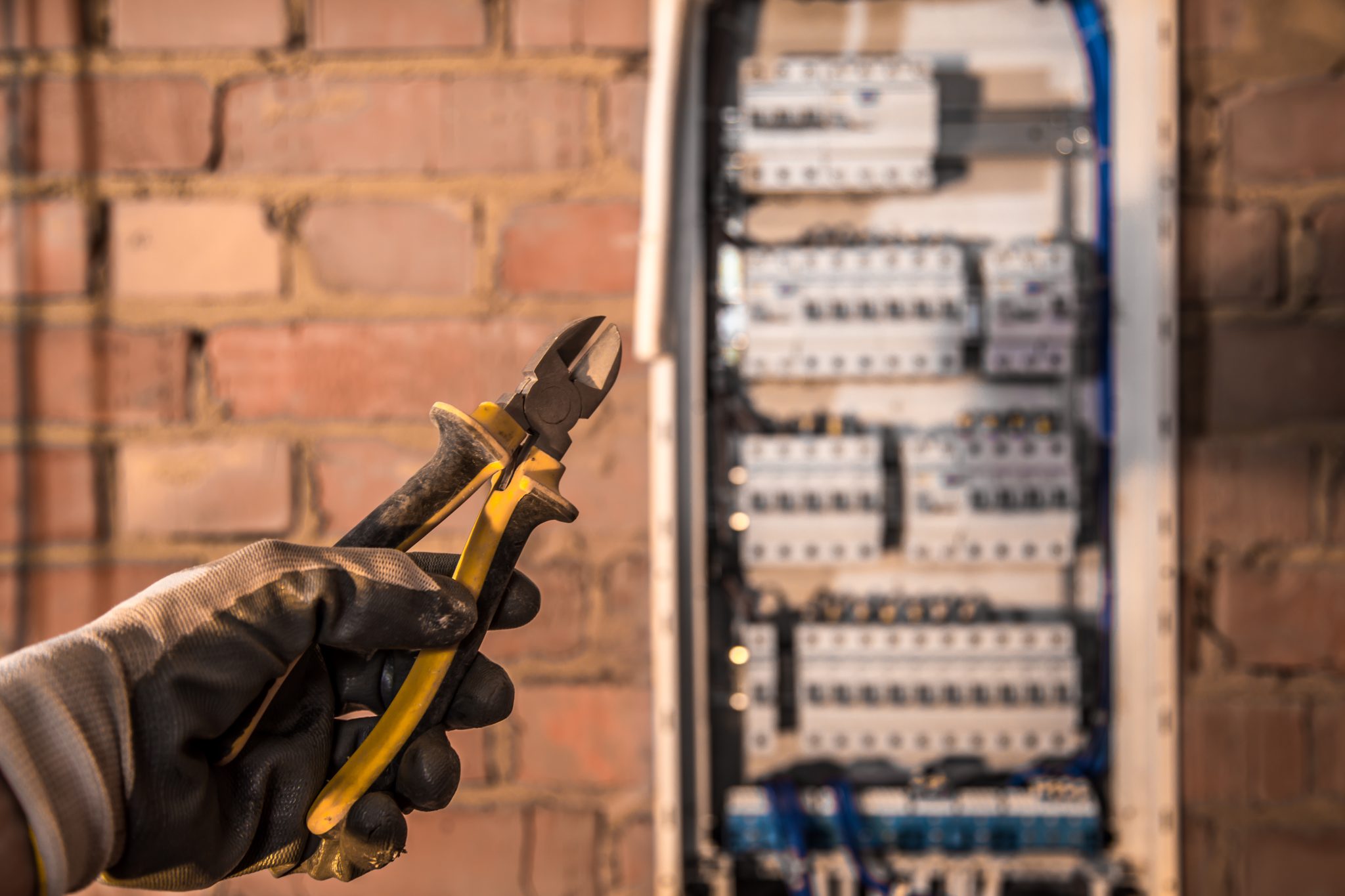 the Assembly of the electrical panel, electrician job, a robot with wires and circuit breakers