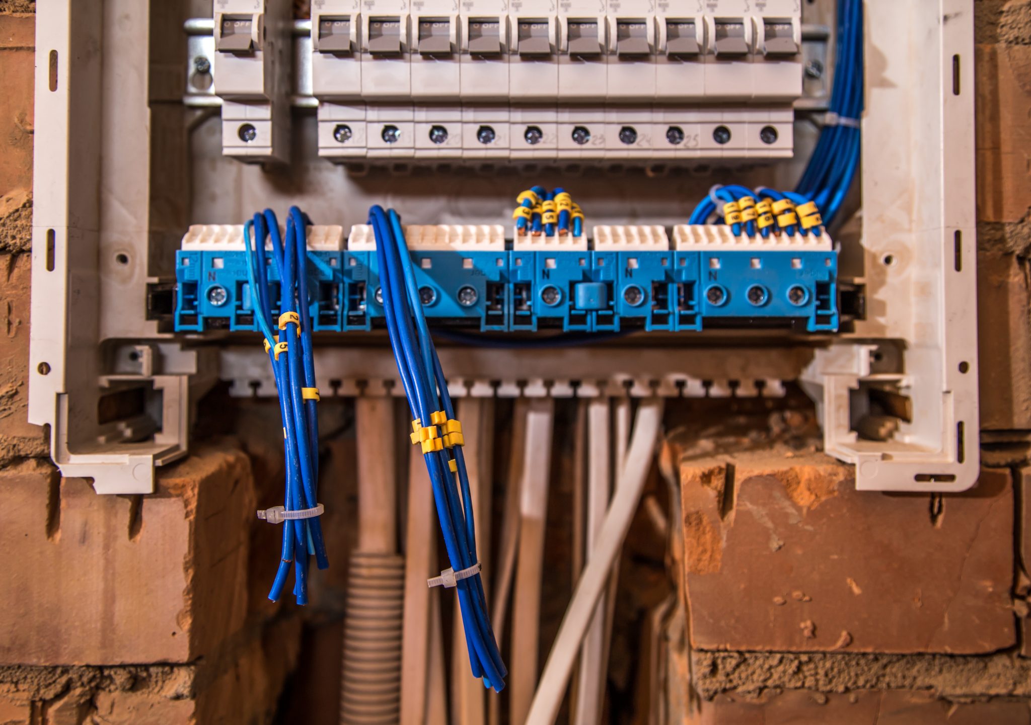 the Assembly of the electrical panel, electrician job, a robot with wires and circuit breakers